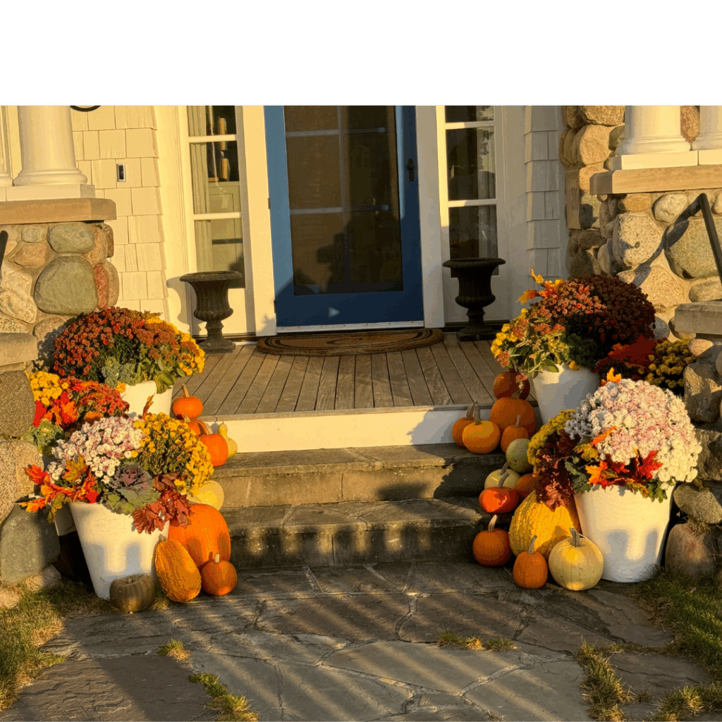 how to decorate for Halloween Front porch decorated with pumpkins and fall-colored flower pots, showing how to decorate for Halloween.